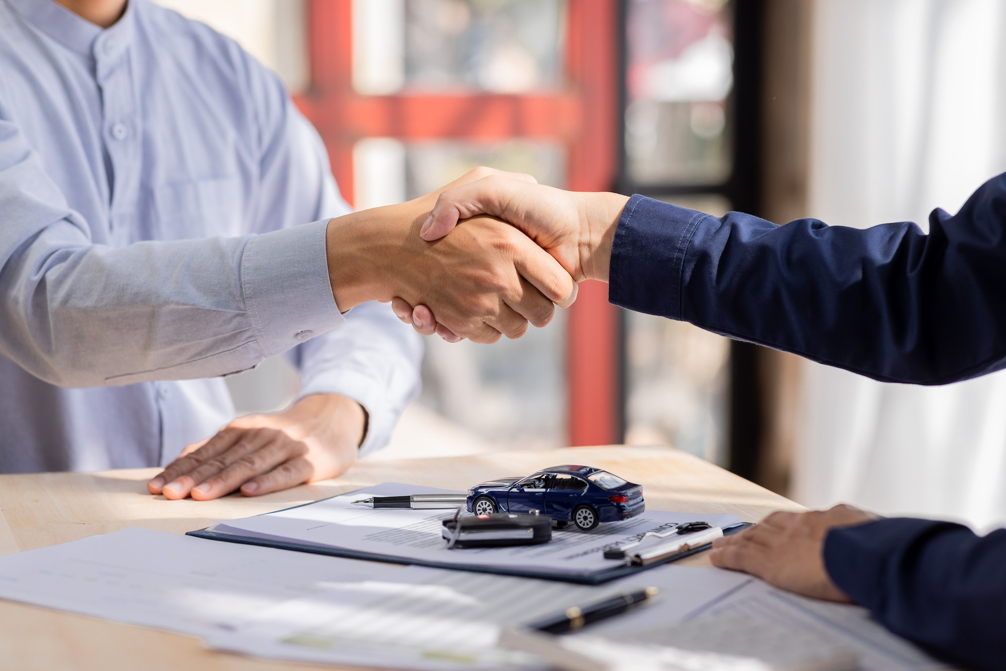 car-rental-service-sales-give-the-car-key-concept-close-up-view-hand-of-agent-handshake-to-the